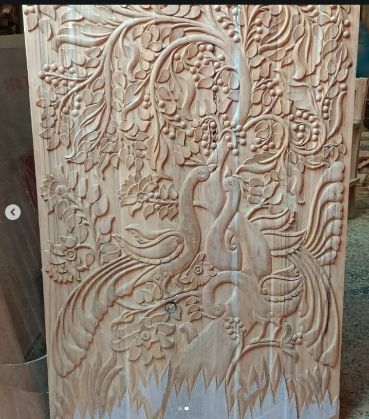 The raw carved wood stage of a peacock gate, before painting